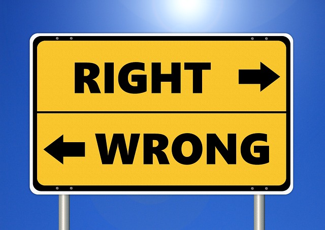 A sign with arrow pointing one way for right and the other for wrong