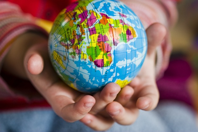 A globe held in a child's hands